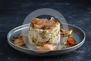 Boiled rice with fried red peppers, carrots and onions, close up