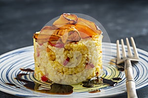 Boiled rice with fried red peppers, carrots and onions, close up