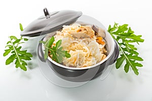 Boiled rice with vegetables and meat in a ceramic bowl