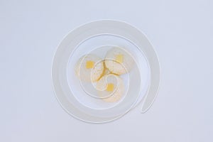 Boiled rice with cheese on white plate close-up on white background photo