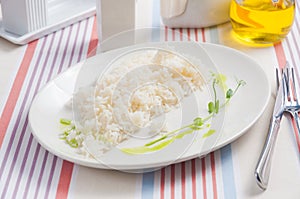Boiled rice on a white plate in a restaurant photo