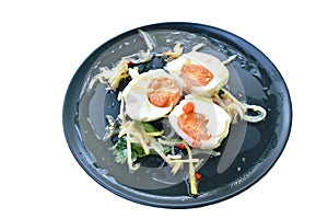 Boiled salty egg half cut with slice ginger salad on plate