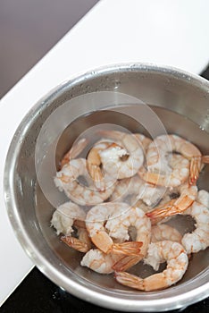 Boiled shrimp prepared in water in metal bowl