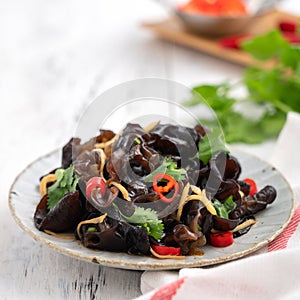 Boiled small black fungus cold dish on white table background