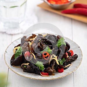 Boiled small black fungus cold dish on white table background