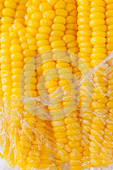 Boiled sweet corn in plastic wrapped package.