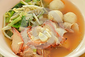 Boiled sweet red barbecue pork and ball with bean sprout in soup on bowl