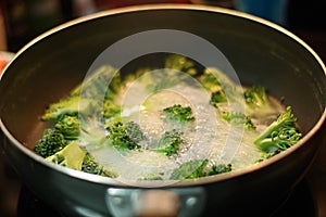 Boiled vegetables, broccoli in a Black Pan