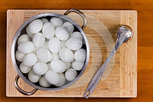 Boiled white hens eggs cooling for decorating