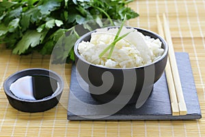 Boiled white rice in a black bowl