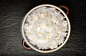 Boiled white rice in ceramic pot.