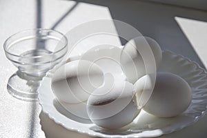 Boiled whole eggs in elegant little white porcelain plate