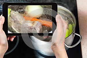 boiling beef broth in steel stewpan close up