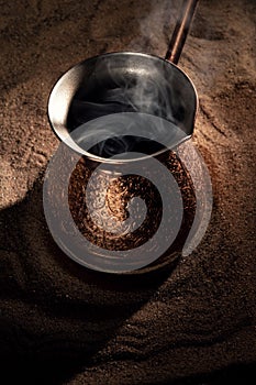 Boiling coffee in copper Turkish coffee brewing pot