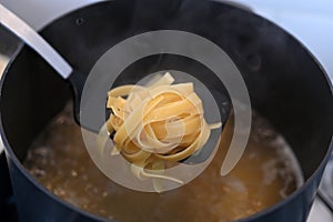 Boiling Fettuccine pasta inside a pot