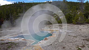 Boiling hot crystal clear water in a geyser. Yellowstone National park. Wyoming, USA