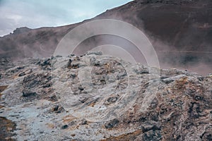 Boiling mudpots in the geothermal area Hverir and cracked ground around, Iceland in summer. Myvatn region,