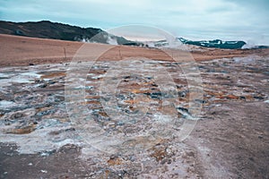 Boiling mudpots in the geothermal area Hverir and cracked ground around, Iceland in summer. Myvatn region,