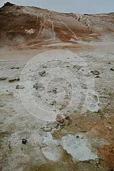 Boiling mudpots in the geothermal area Hverir and cracked ground around, Iceland in summer. Myvatn region,