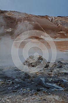 Boiling mudpots in the geothermal area Hverir and cracked ground around, Iceland in summer. Myvatn region,