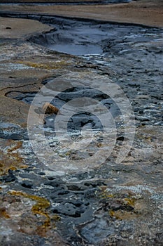 Boiling mudpots in the geothermal area Hverir and cracked ground around, Iceland in summer. Myvatn region, North part of Iceland