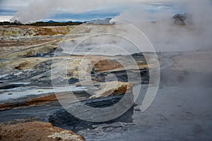 Boiling mudpots in the geothermal area Hverir and cracked ground around, Iceland in summer. Myvatn region, North part of Iceland