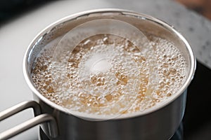 Boiling pasta in a saucepan on home kitchen