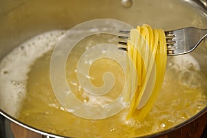 Boiling pasta spaghetti in pot. penne rigate pasta- Cooking pasta in boiling water