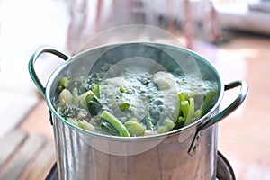 A boiling pot of vegetable soup