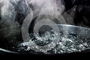 Boiling pot of water with steam