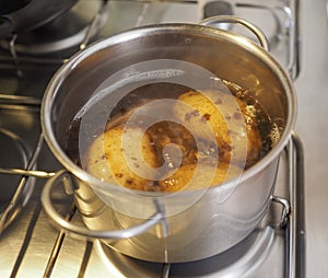 Boiling potato in saucepan