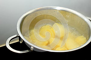 Boiling potatoes in a pan