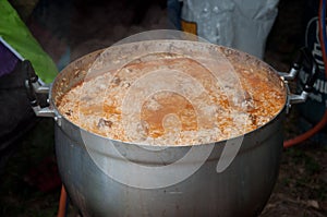 Boiling rice with buried goat meat