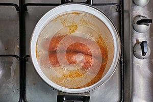 Boiling sausages on stove