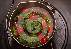 boiling survival tea with rose hips and leaves