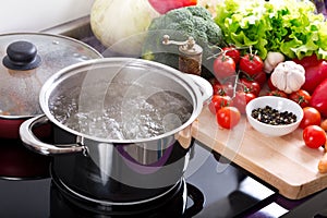 Boiling water in a cooking pot on the cooker