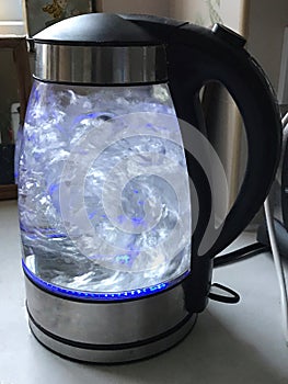 Boiling water in a glass kettle appliance photo