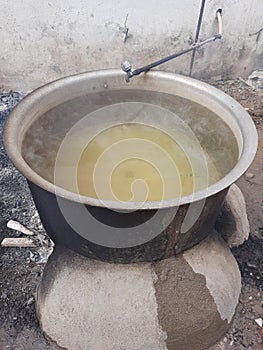 Boiling the water on a mud chulha or clay stove photo