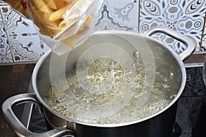 boiling water in pan and pasta in package