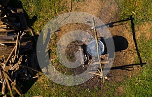 Boiling water in pots above the fire