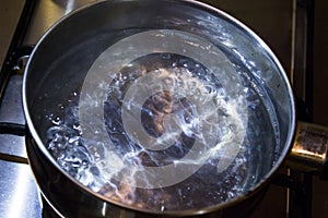 Boiling water in a steel casserole pot