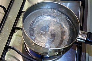 Boiling water in a steel casserole pot