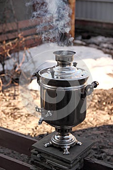 Boiling water for tea in a samovar at the morning, at the beginning of spring