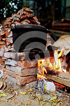 Boiling the water using traditional stove made from brick and wood