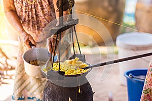 Boiling yellow silkworm cocoons by boiler to make silk thread