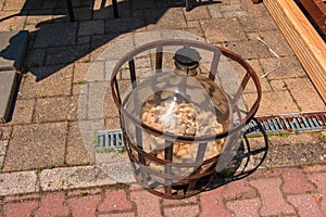 Large wine bottle with used corks for wine in metallic frame. Decoration in a beer bar