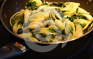 Bok Choy cooking in pan photo