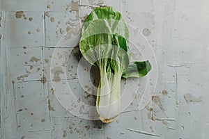 bok choy on a gray textured surface photo