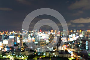 Bokeh abstract background of skyscraper buildings in Bangkok city, Thailand with lights, Blurry photo at night time. Cityscape