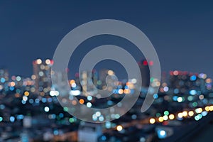 Bokeh abstract background of skyscraper buildings in Bangkok city, Thailand with lights, Blurry photo at night time. Cityscape